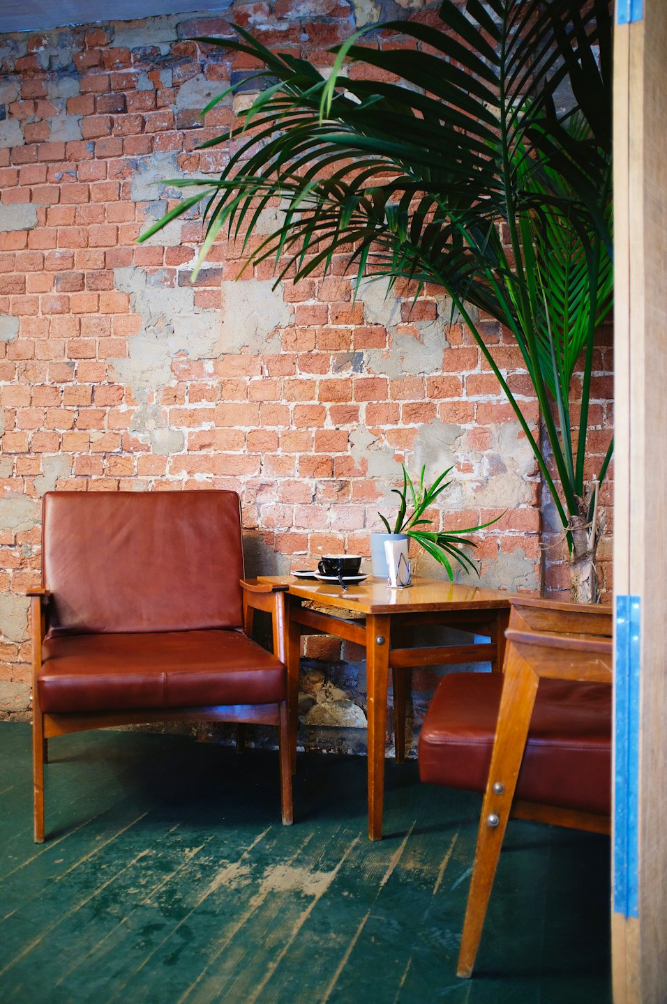 Two brown leather armchairs sit beside a small coffee table.
